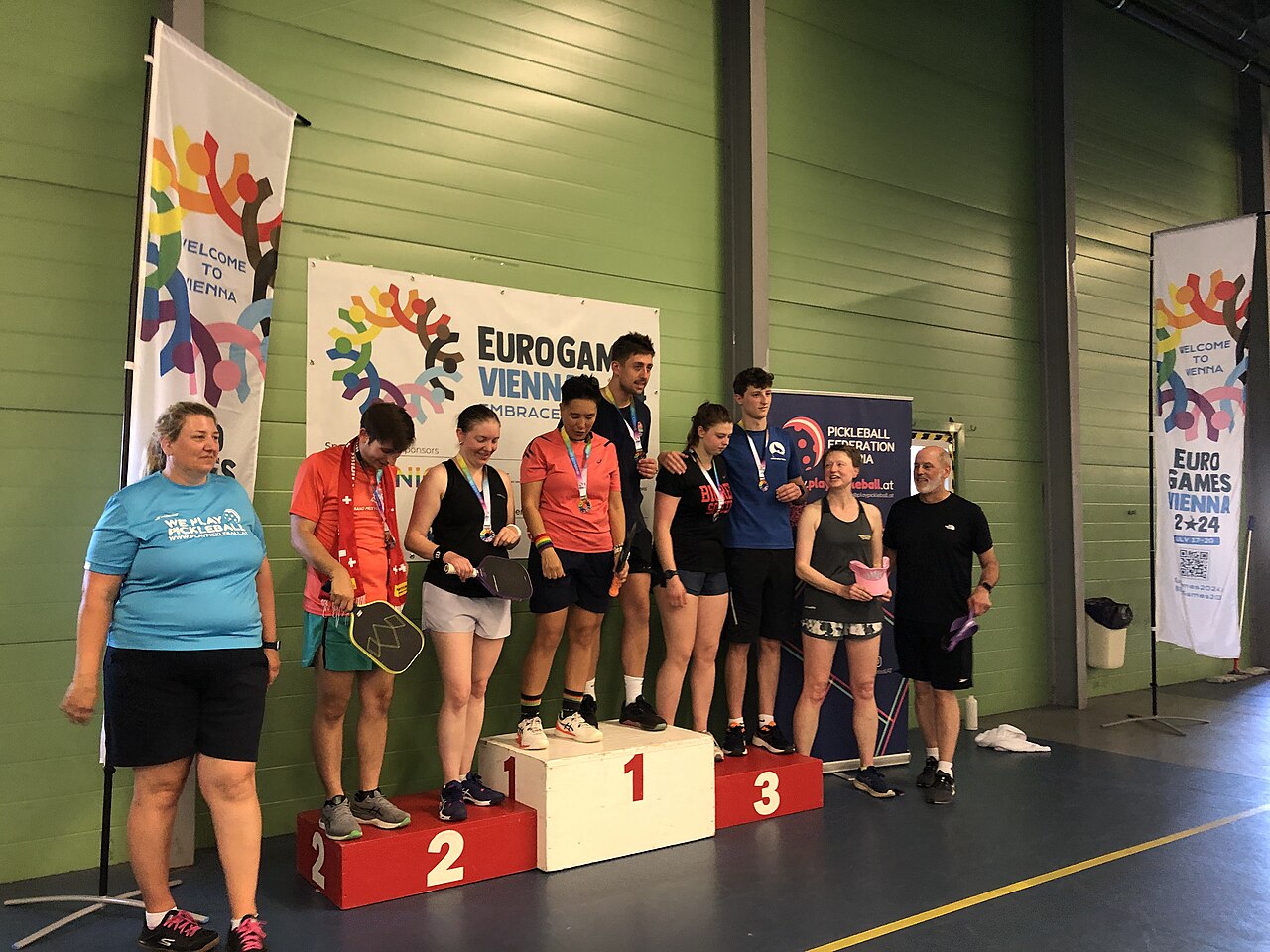 Players celebrate on the podium after the EuroGames 2024 pickleball competition in Vienna; this is an archival event reference, not a Miami tournament photo.